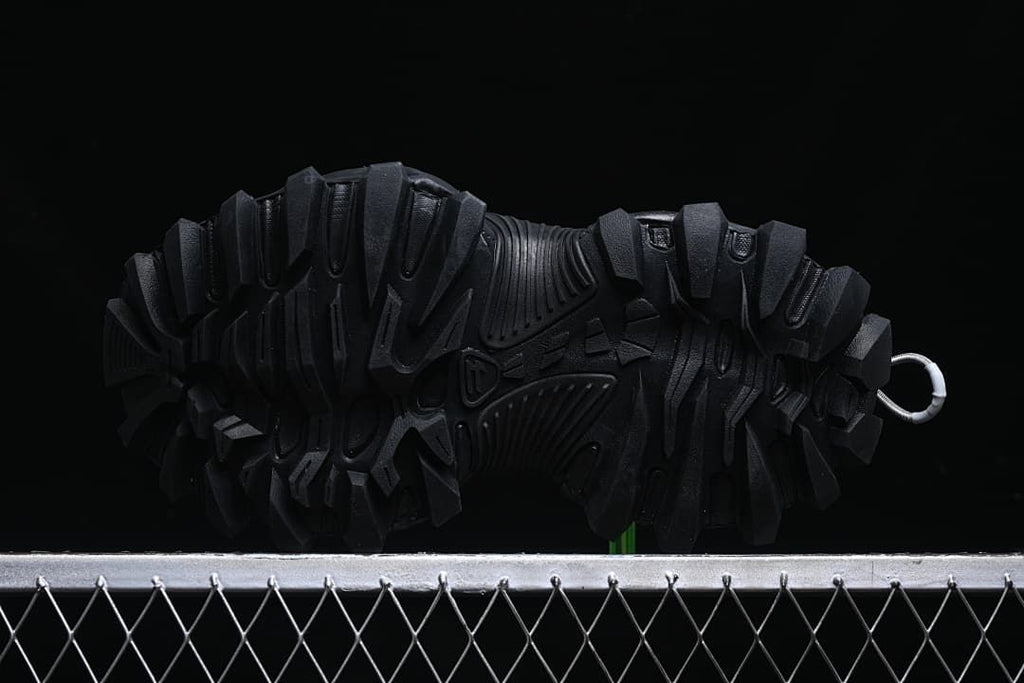 Underside view of the outsole with deep, angular lugs.