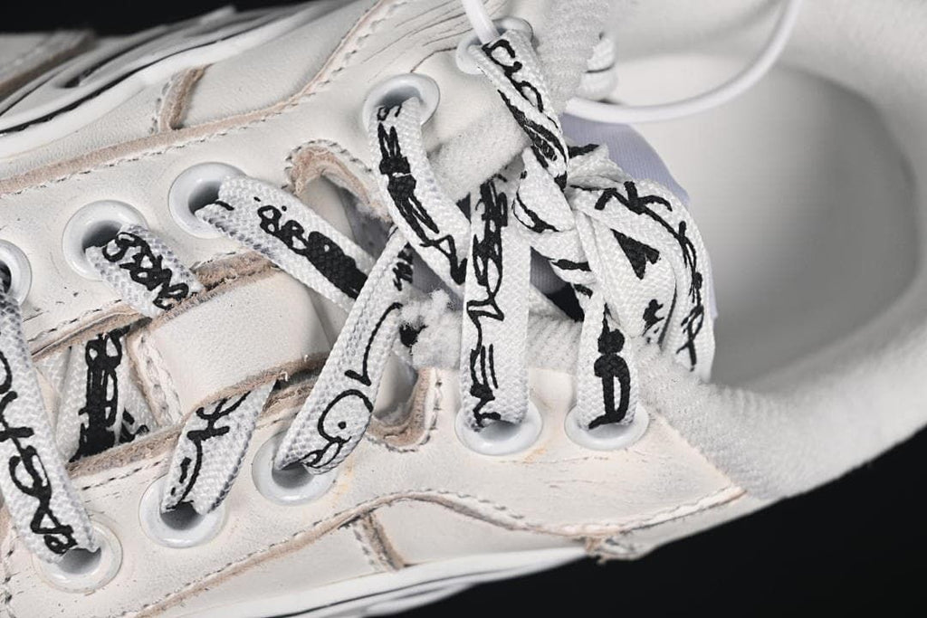 Close-up of white laces with black graphics and lace eyelets