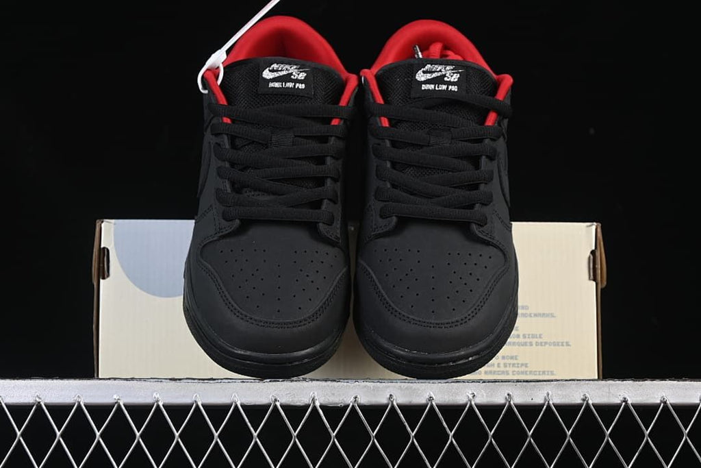 Front view of the pair showing black perforated toes, black laces, and red lining