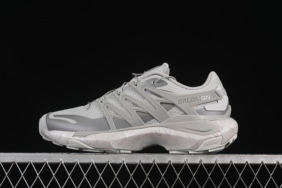 Side view of a light grey Salomon XT Pu.re Advanced shoe against a black background