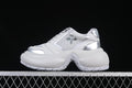 Side view of a gray-and-silver SMFK Future Ripple sneaker with a sculpted sole