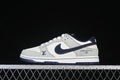 Side view of pale blue, white, and navy SB Dunk Low sneakers with denim-style panels