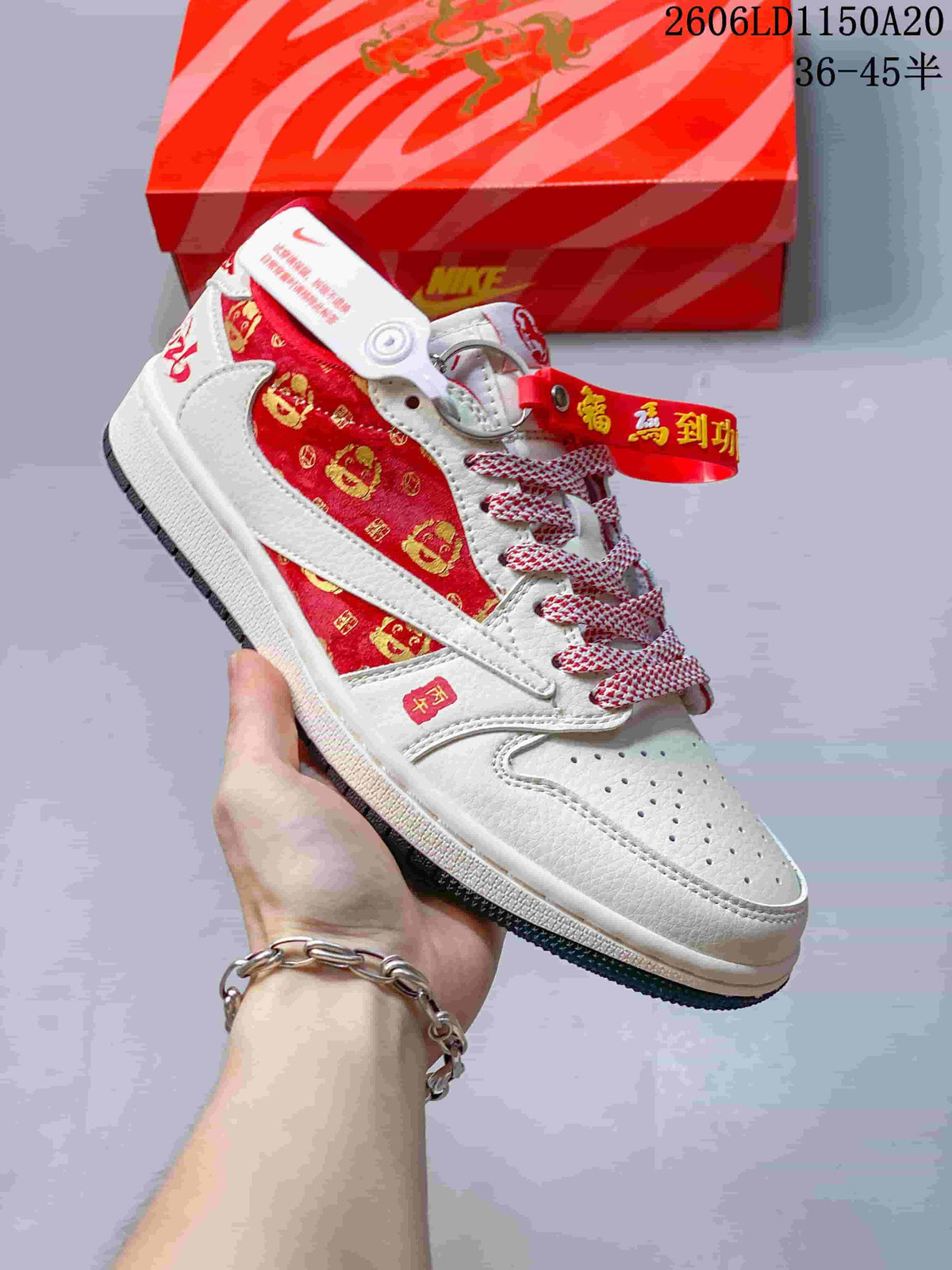 Close view of a white sneaker with a red patterned side panel, contrasting side stripe, and patterned laces.