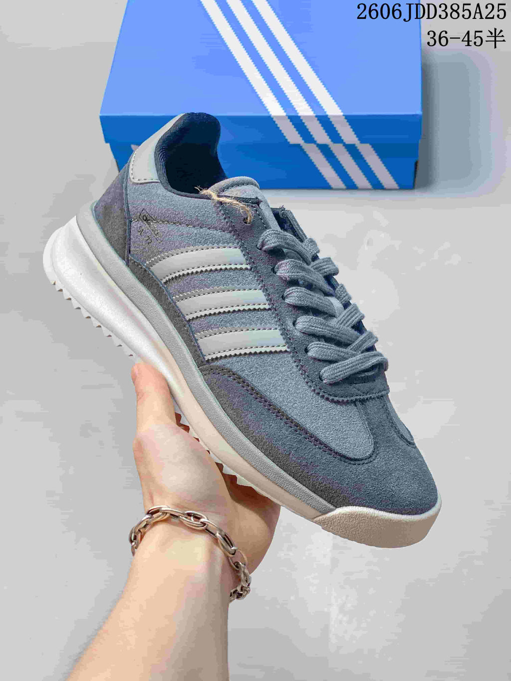 Angled side view of the grey adidas SL 72 sneaker with three-stripe detailing