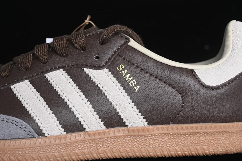 Close-up of the Samba wordmark, off-white stripes and brown upper