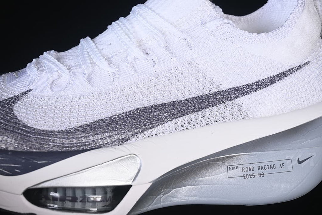 Close-up of knit-look upper, grey Swoosh, and sculpted sole