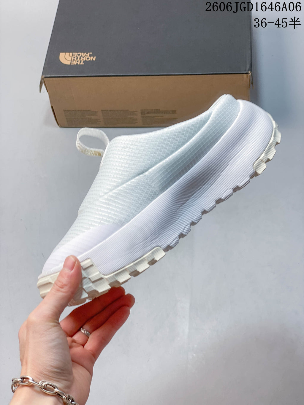 Side view of the pale white slip-on mule with chunky outsole