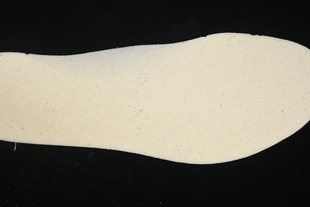 Light-colored shoe insert shown by itself.