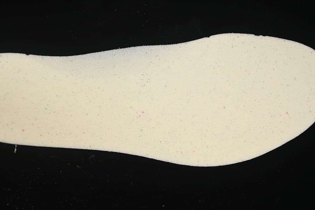 Light-colored shoe insert shown by itself.