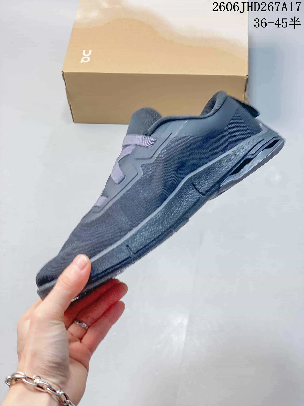 Side profile of a slate-blue sneaker with a chunky sole and elastic lacing.