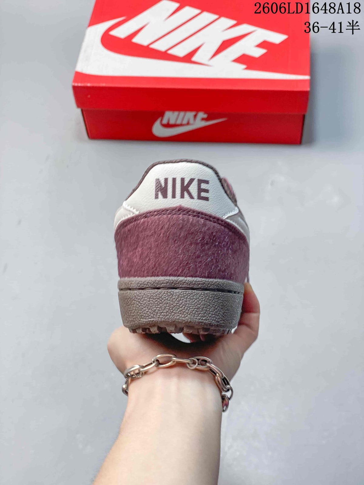Rear view showing the burgundy heel and light-colored heel tab