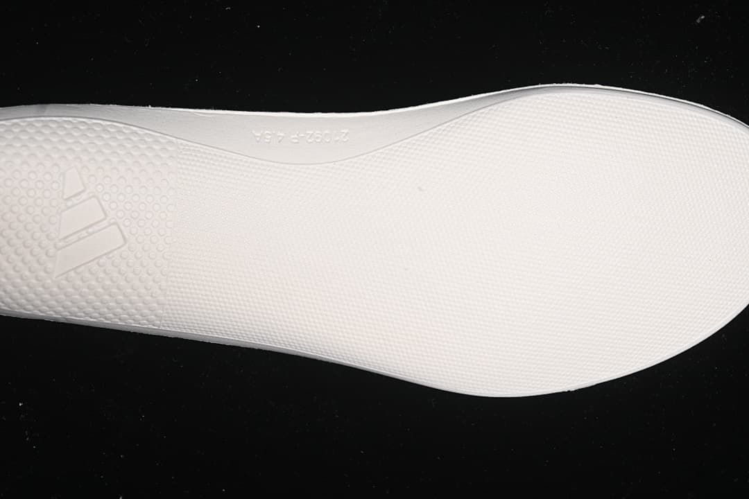 Close-up of the textured outsole of the pink running shoe