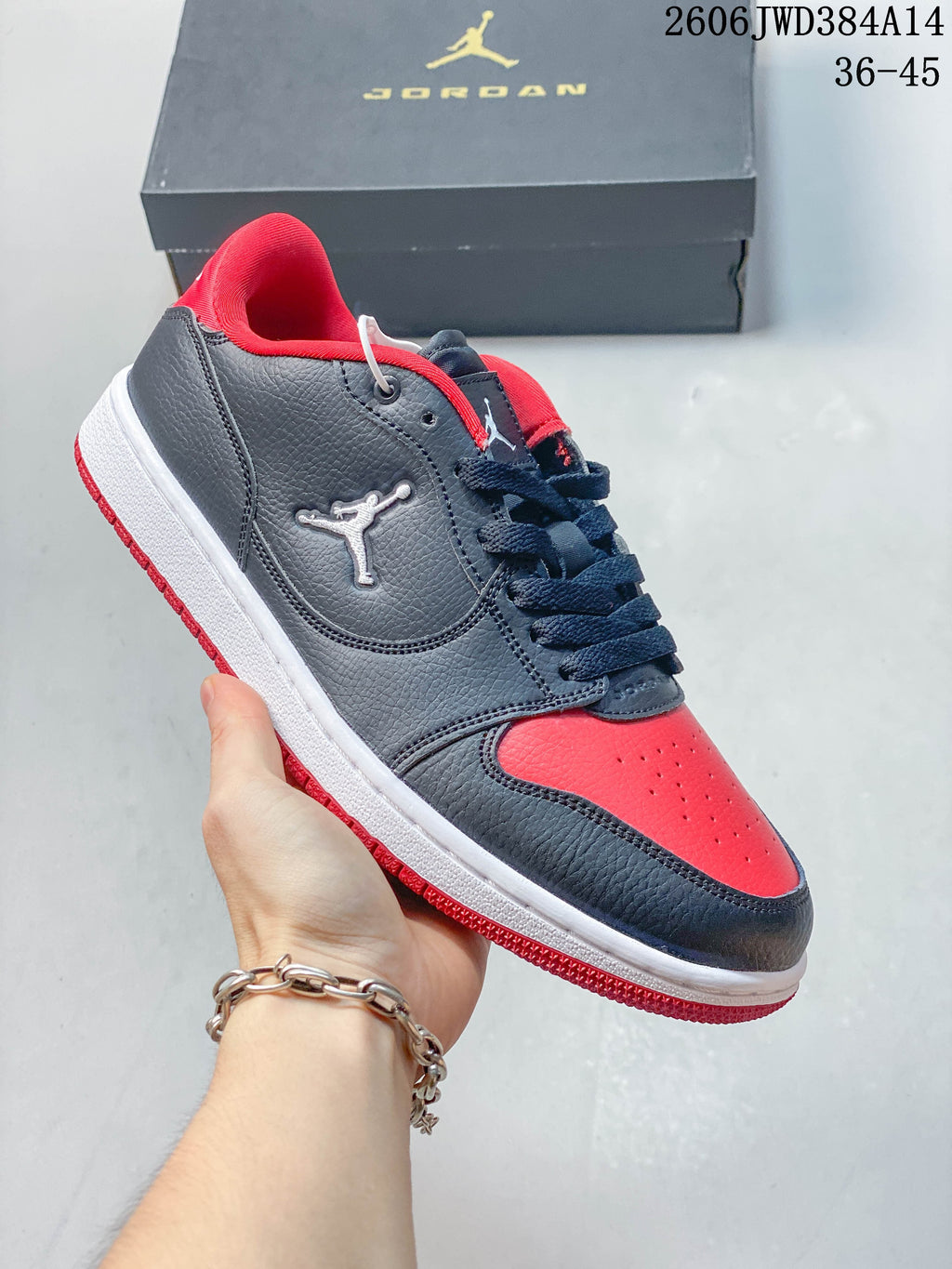 Side view of a grey Jordan Court Connect low-top with red accents