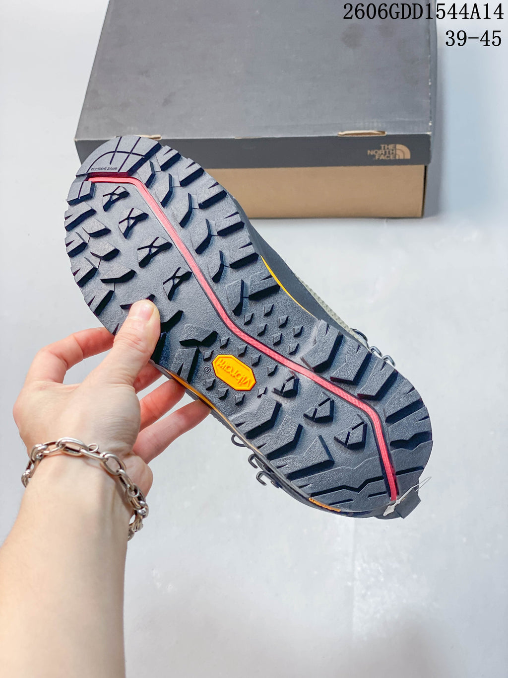 Close-up of the lugged boot outsole, showing a Vibram mark.