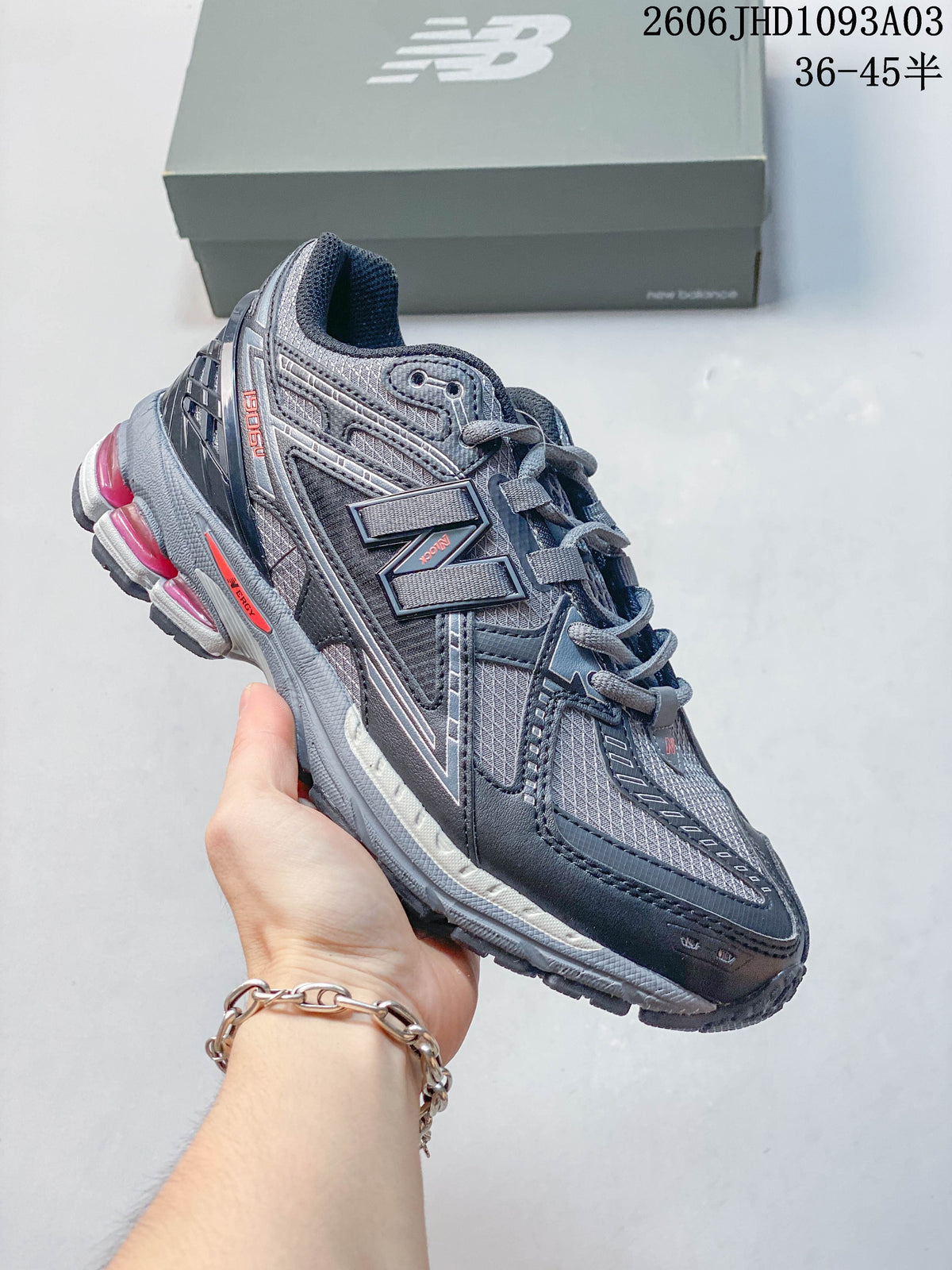 Charcoal gray New Balance 1906U sneaker with bright pink sole accents