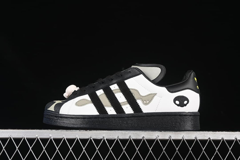 Side view of the white and black sneaker with decorative accents