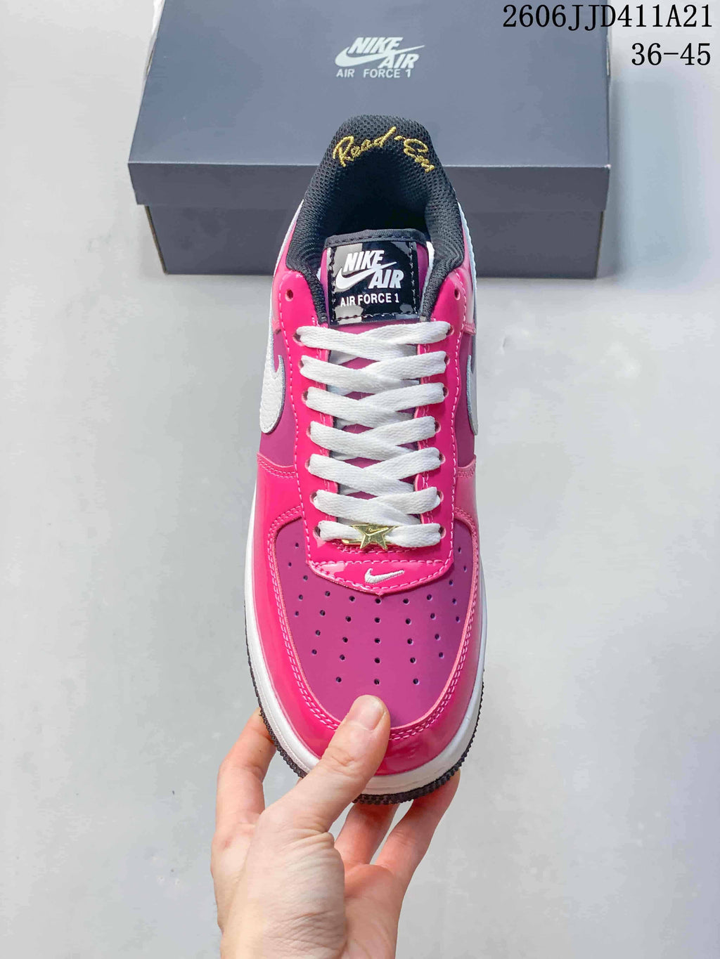 Top view of a pink and purple Nike Air Force 1 Low showing perforated toe and white laces