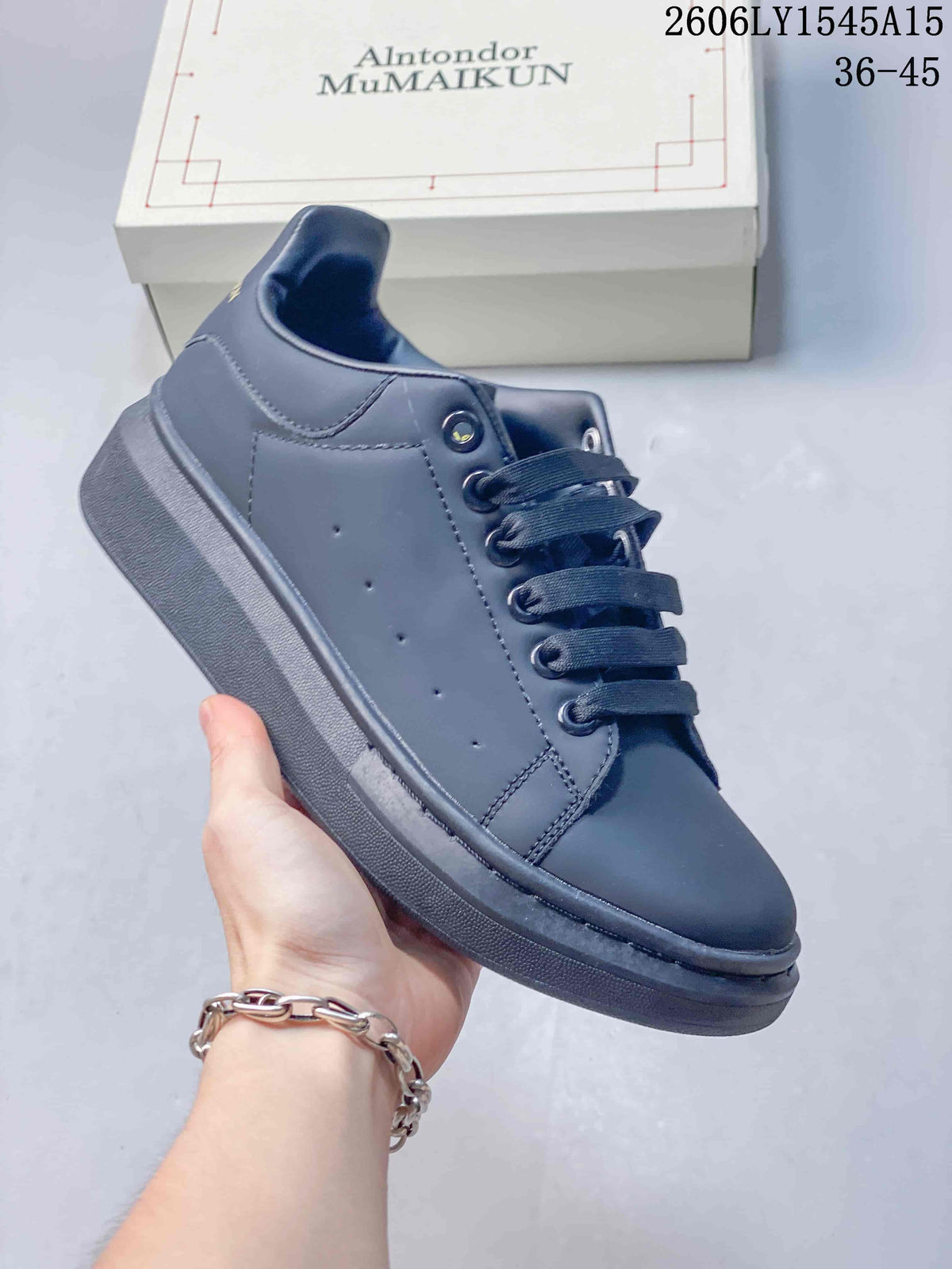 Side view of a dark grey sneaker with a matching sole and perforated side panel.