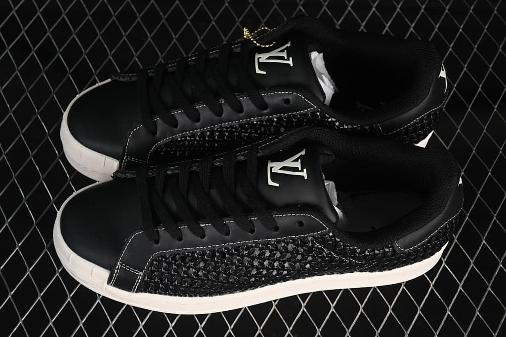 Pair of black Superstar sneakers shown from above at an angle