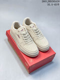 Pair of cream Puma Caven 2.0 low-top sneakers on a red shoe box