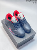 Pair of dark charcoal Jordan low-top sneakers with red lining and light tongues on a shoebox.
