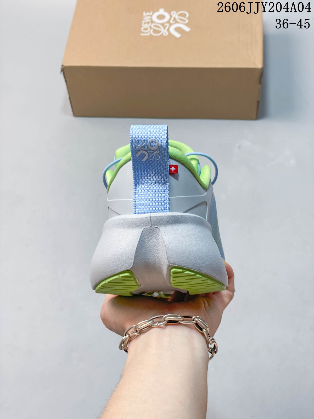 Rear view of a sneaker showing a blue heel pull tab, padded green collar, and sculpted white heel.