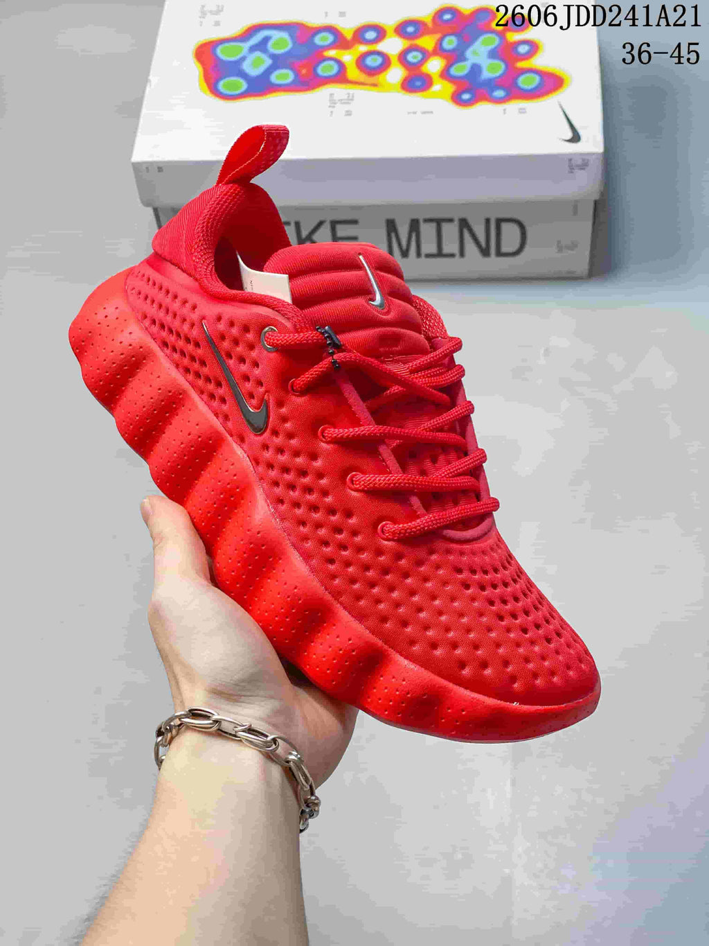 Bright red Nike Mind 002 SP FK shoe with a matching sculpted outsole.