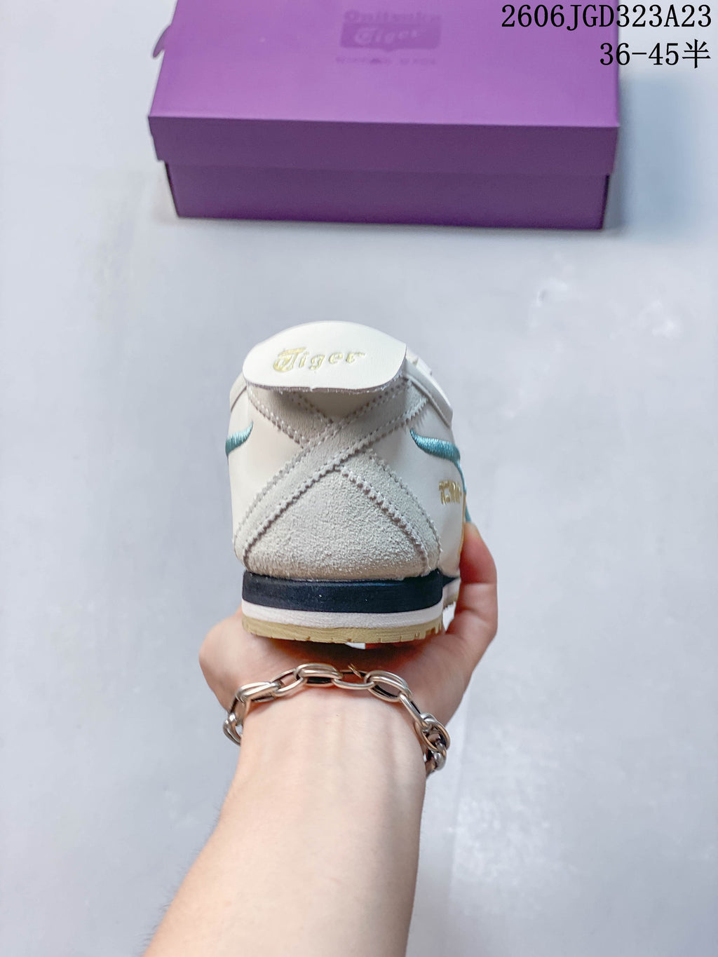 Heel view of an ivory Onitsuka Tiger Mexico 66 NM sneaker