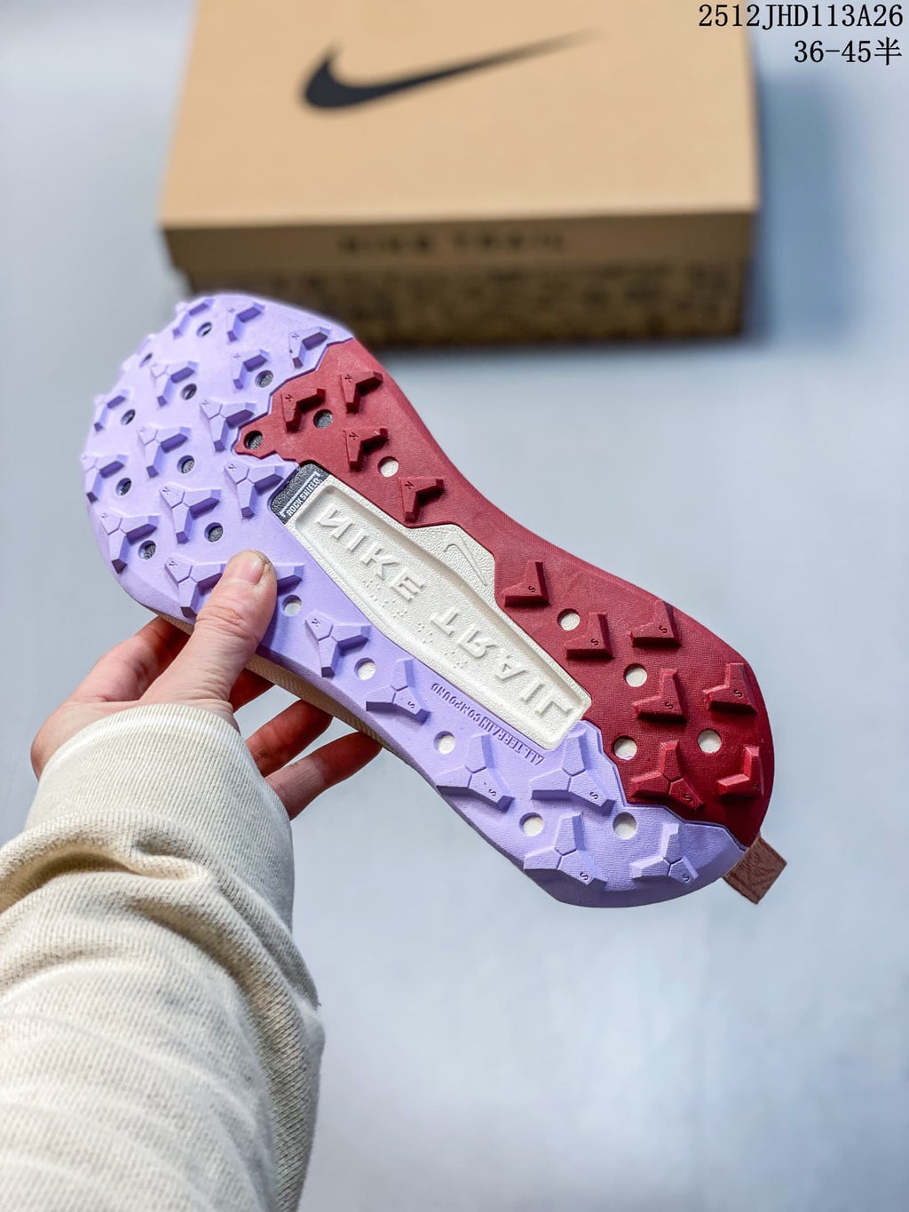 Close-up of the Nike Wildhorse 10 lugged outsole in burgundy and lavender tones.