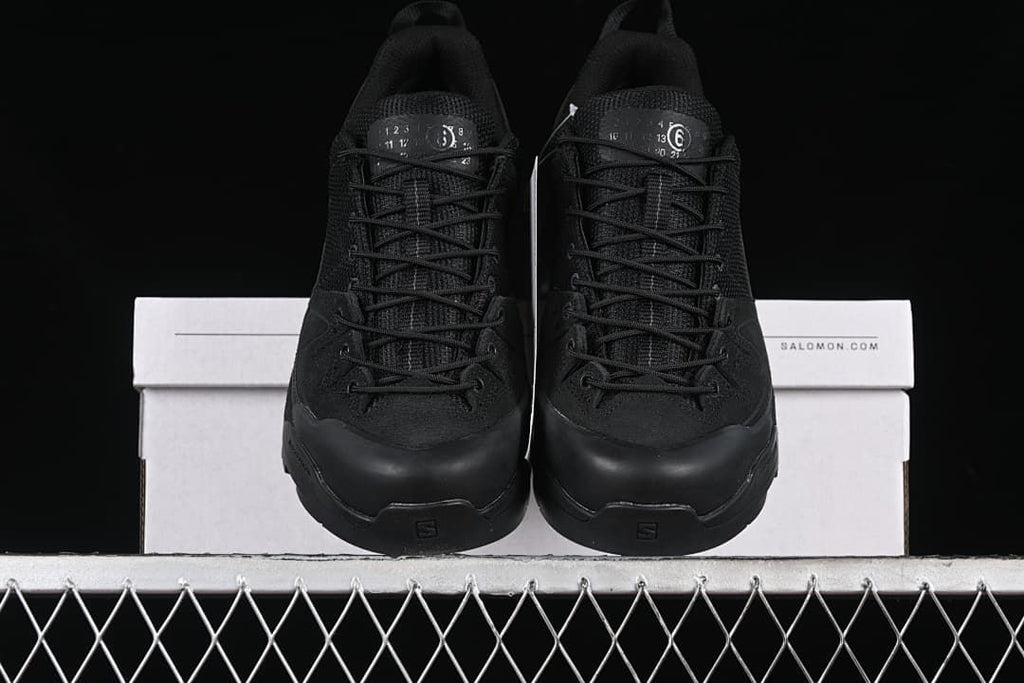 Front view of the pair of black lace-up sneakers