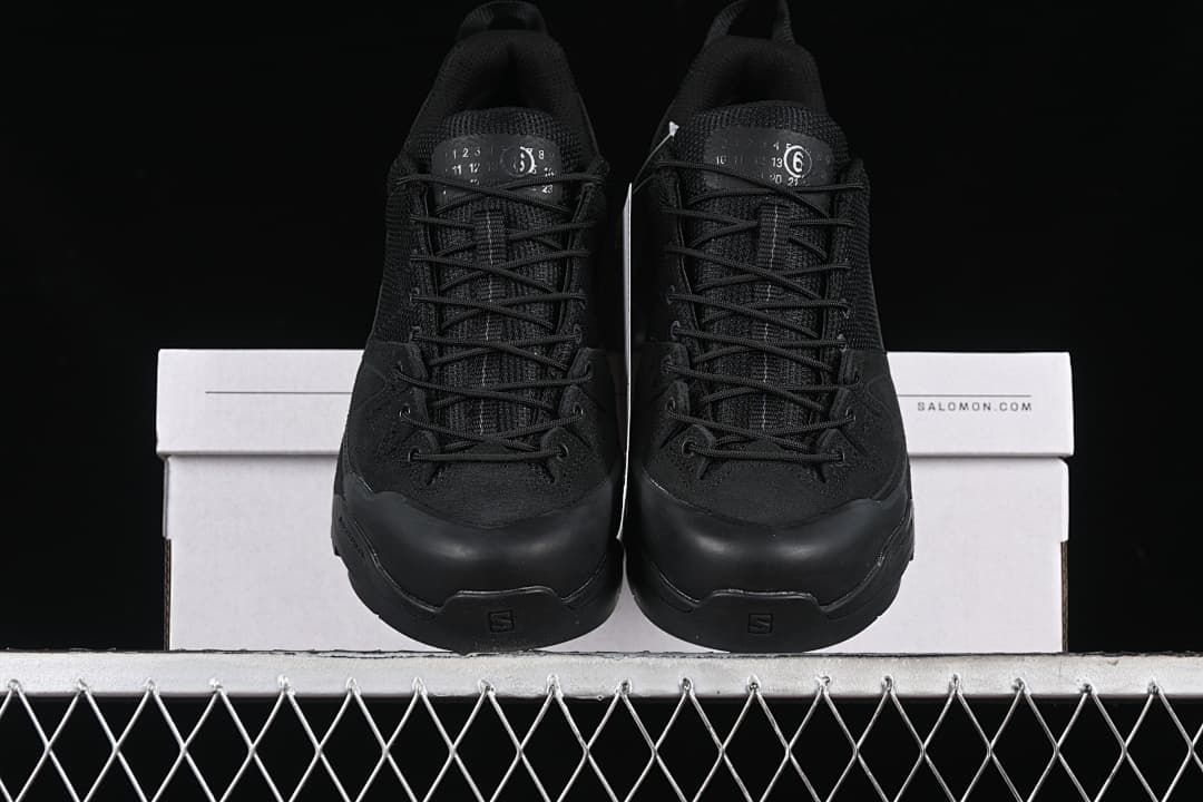Front view of the pair of black lace-up sneakers