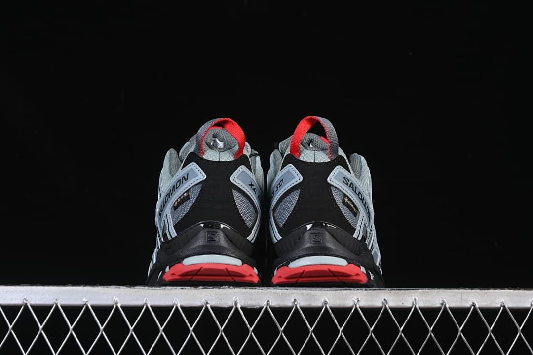 Rear view of both shoes showing red heel accents