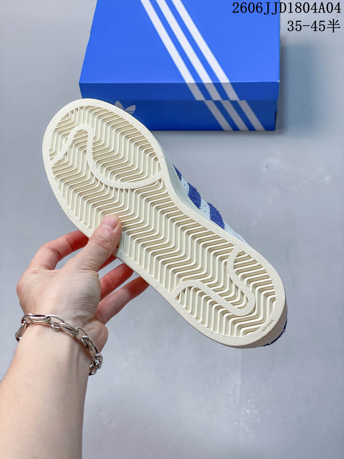 Underside view showing the patterned cream-toned outsole of a sneaker