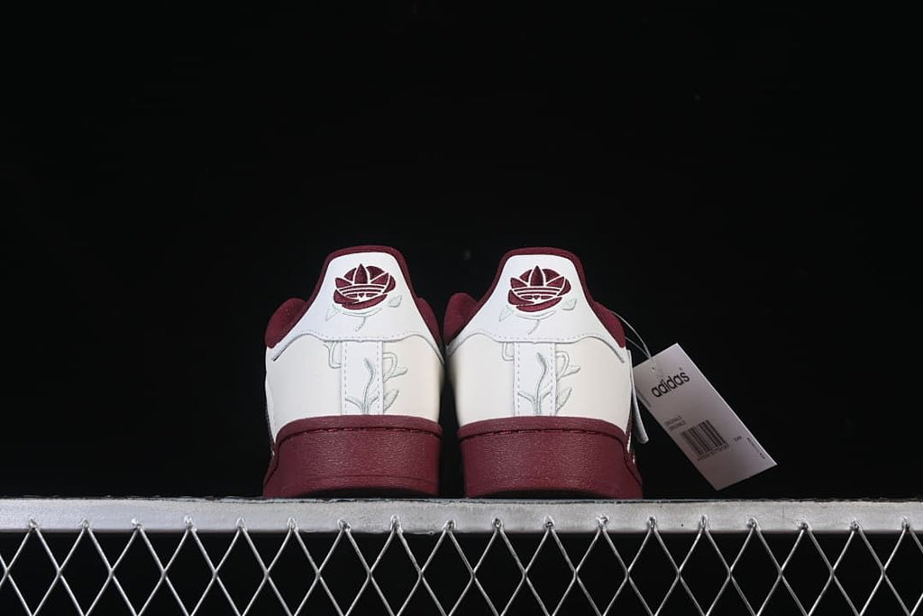 Rear view of both sneakers with embroidered heel details.