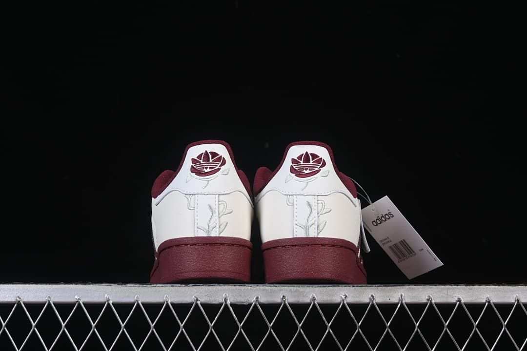 Rear view of both sneakers with embroidered heel details.
