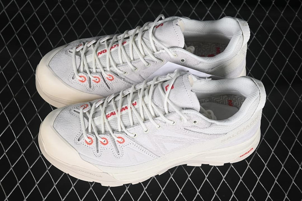 Pair of light-colored X-ALP shoes viewed from above at an angle