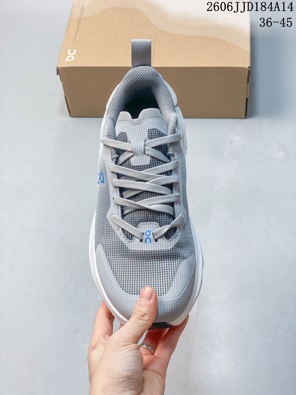 Top view of the gray lace-up sneaker with blue branding details