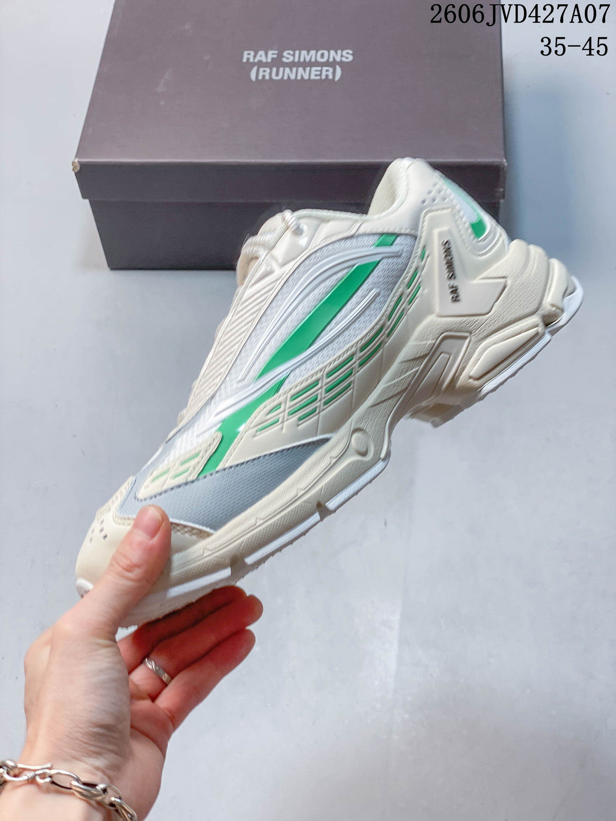 Side profile of a cream Raf Simons Cylon-21 sneaker with green accents