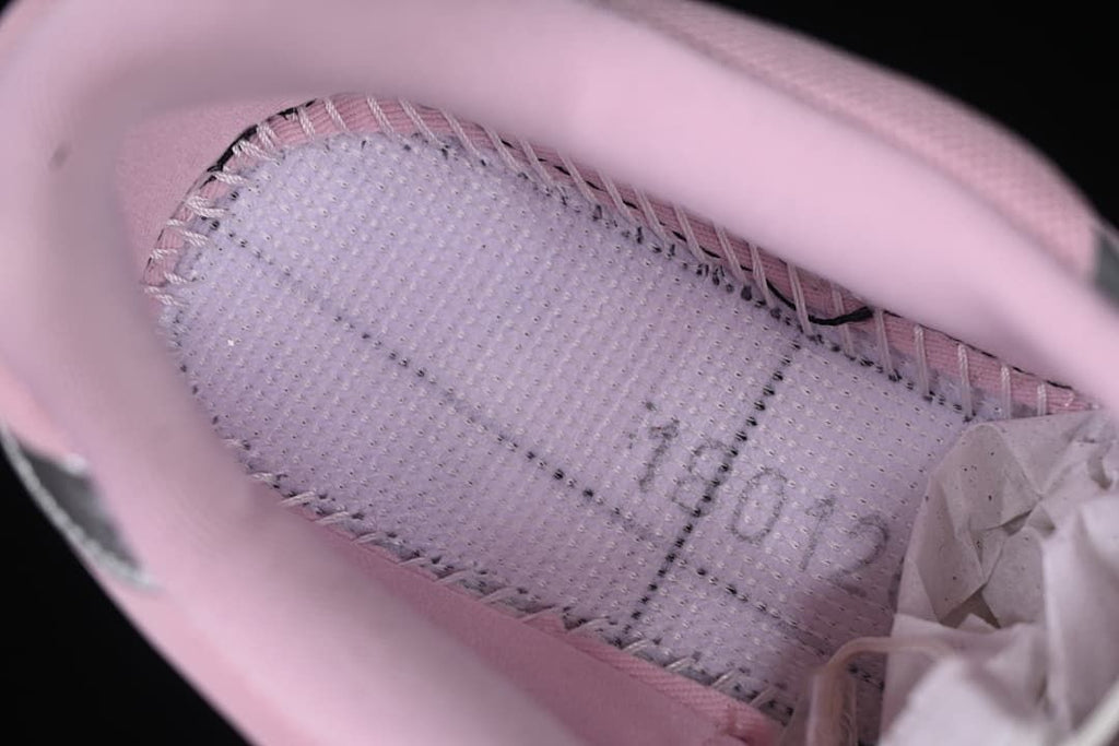 View inside the pink sneaker showing the footbed and lining
