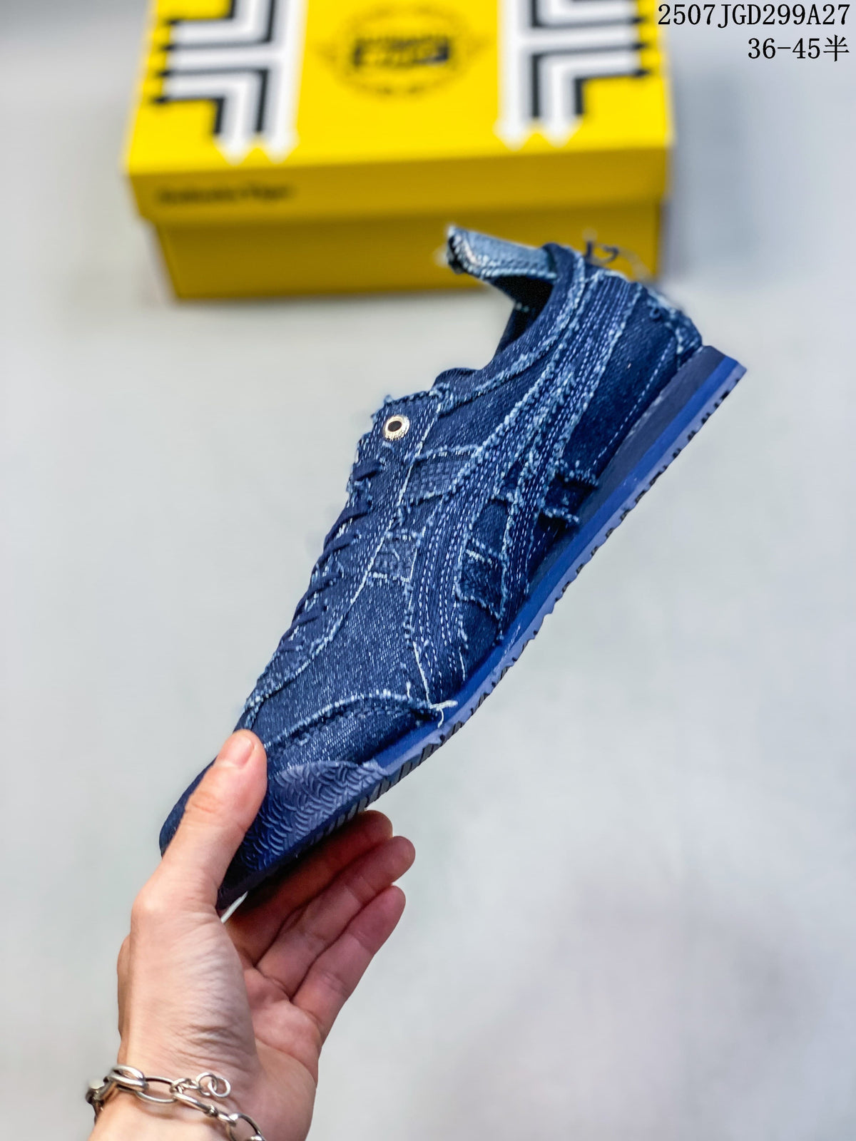 Side profile of a dark blue distressed denim-look sneaker