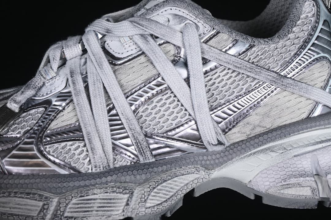 Close-up of layered grey and silver-toned upper panels and laces