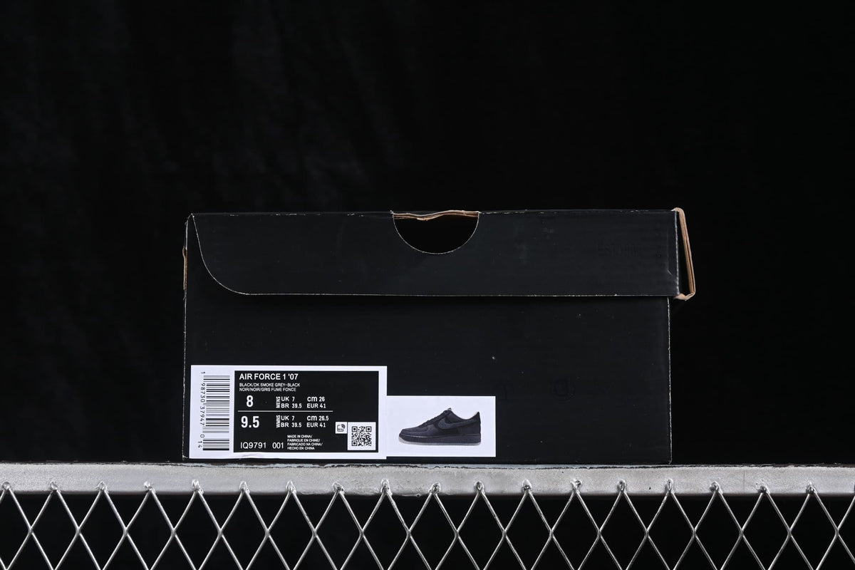 Black Nike shoe box with a label identifying Air Force 1 '07, color information, style code IQ9791-001, and a photographed size of EU 41.