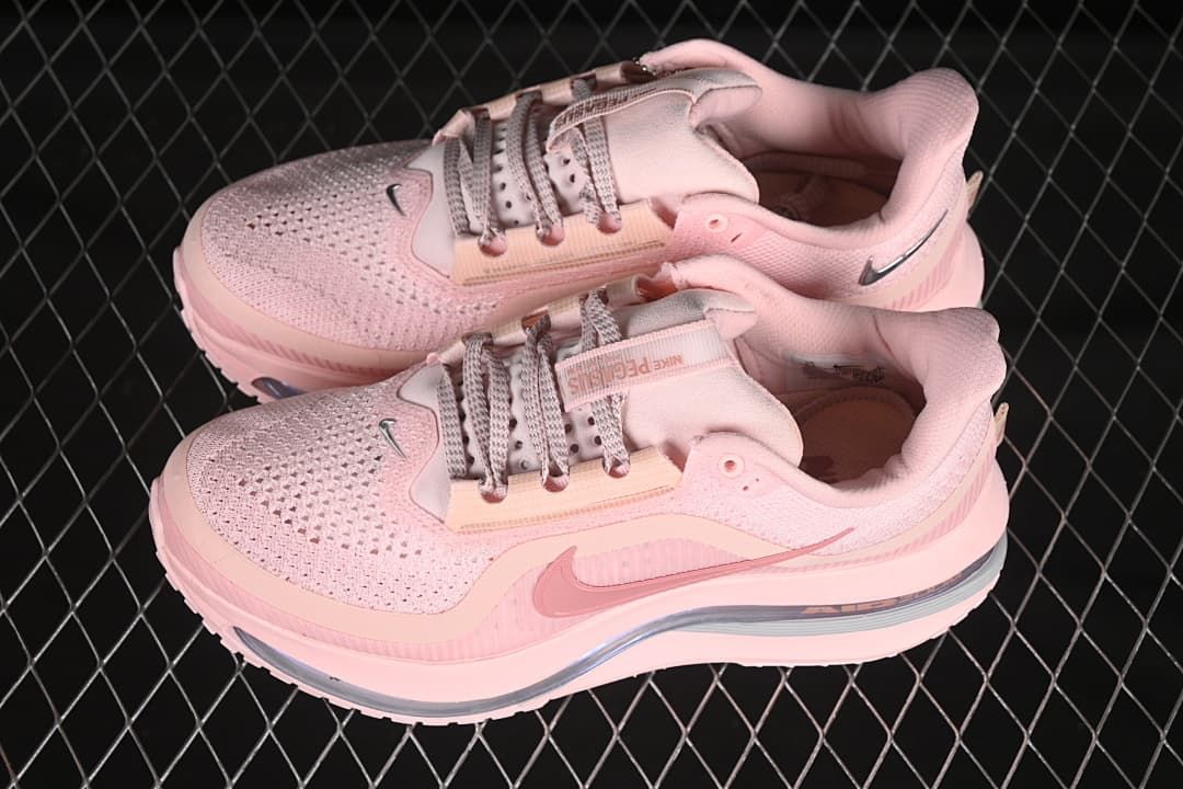 Pair of pink Nike running shoes shown from a three-quarter angle