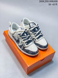 Cream and navy patterned low-top sneakers shown from above on an orange shoe box.