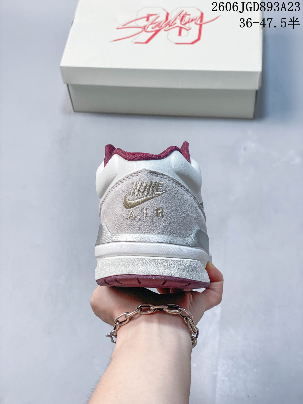 Rear view showing the heel panels, embroidered branding and burgundy trim