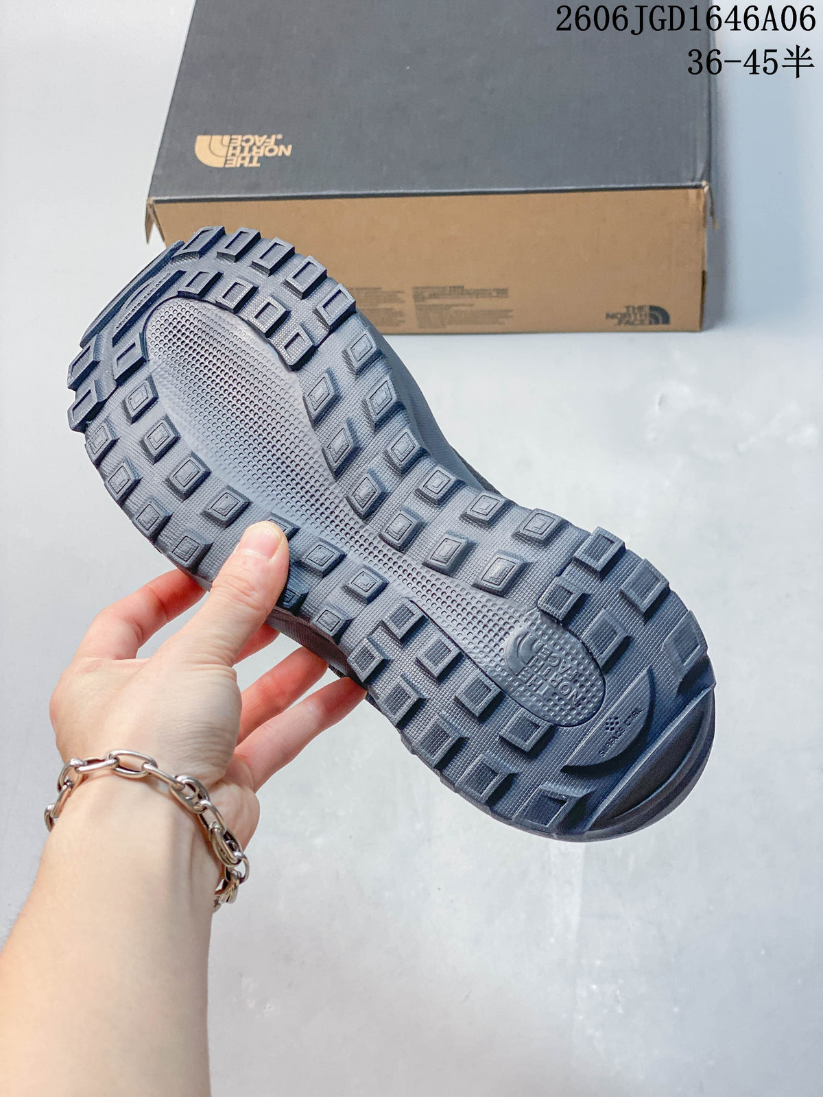 Close view of the deeply lugged outsole on a charcoal mule shoe