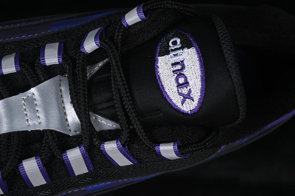 Close-up of the tongue badge, black laces, and silver lace details
