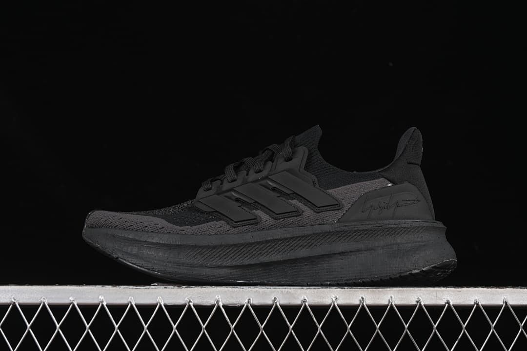 Black sneaker in side profile against a dark background