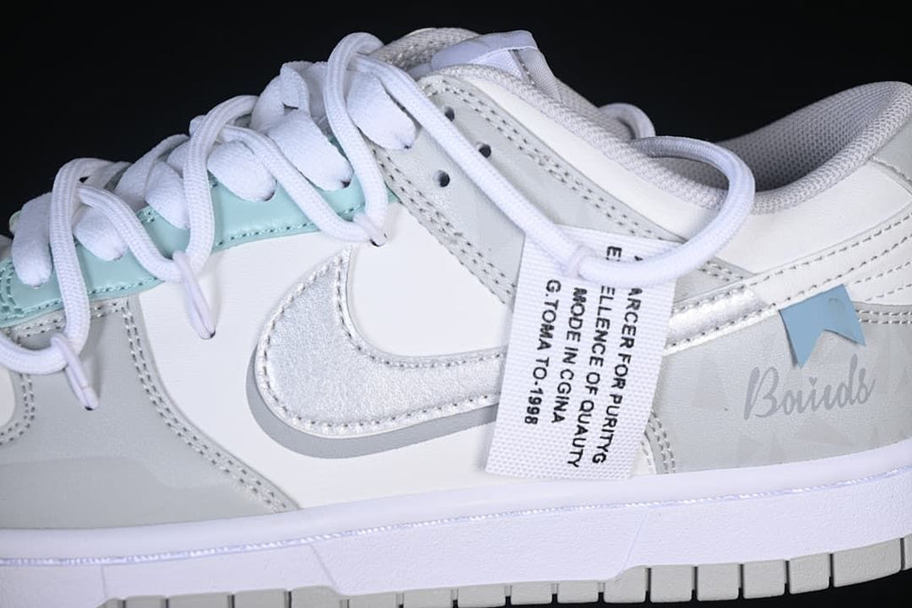 Side detail showing the Swoosh, pale aqua accents and hangtag
