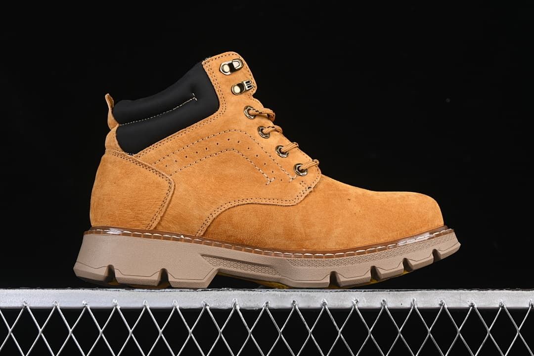 Side profile of a wheat-colored mid-top boot with a chunky lugged outsole